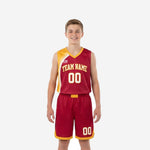 Custom maroon youth basketball uniforms with gold curved shoulder panel, V-neck binding, and matching shorts with chevron hem, front view full set