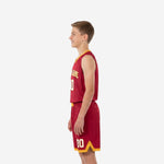 Side view of custom maroon and gold youth basketball uniforms showing curved shoulder panel and gold shorts chevron hem detail