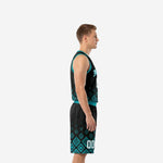 Side view of custom black and teal men's basketball uniform set showing V-neck binding, Aztec pattern on jersey hem and full shorts leg panel