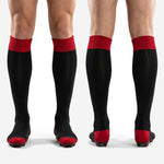 Custom mens black and red soccer match socks side view with red cuff band and reinforced toe