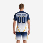 Close detail of custom men's soccer jersey in navy gradient with gold cuff trim and full-dye sublimation print finish