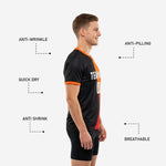 Back view of custom mens soccer practice jersey showing player surname and number print zones on black and orange sublimated fabric