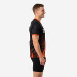 Custom mens soccer practice jersey showing orange ember graphic rising from hem on left side profile