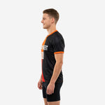 Custom mens soccer practice jersey black and orange gradient panel, right side view showing dark red lower transition