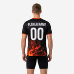 Close detail of full-dye sublimation orange fire and ember scatter graphic on black soccer training jersey