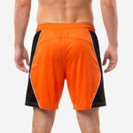 Close-up of black elastic waistband with orange drawcord on custom mens soccer shorts in orange and black