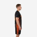 Men's soccer team uniform set in black and orange stripe sublimation print, left side profile showing tapered stripe panel running from armpit to hem on jersey and shorts