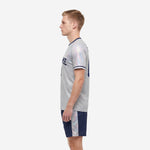Custom men's soccer uniform set in Silver-Grey with Navy Blue shorts and iridescent side panels, right side view