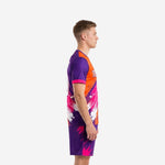 Men's soccer team uniform side view showing orange and royal purple splash jersey with matching purple shorts