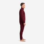 Side profile of custom mens soccer tracksuit in solid maroon showing slim athletic cut and stand collar full-zip jacket