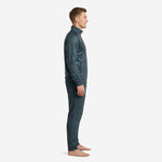 Custom mens soccer tracksuit in Steel Blue with teal geometric pattern, side view showing raglan sleeve and tapered pant leg construction