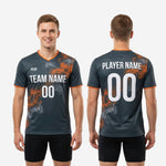 Orange contrast trim on sleeve cuff of custom mens soccer training top in graphite smoke print