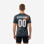 Custom mens soccer training top in graphite and orange, back view showing back number print zone