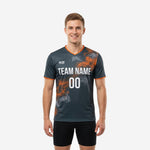 Custom mens soccer training top in graphite with orange smoke sublimation print, front view on male model