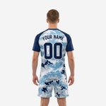Detail view of custom men's soccer jersey in digital camo pattern with Navy Blue crew neck and raglan sleeve contrast