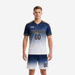 Custom men's soccer uniform in navy blue to white gradient with gold trim stripes, front view showing team name and number on jersey and matching shorts