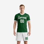 Custom men's soccer uniforms in Forest Green and White, V-neck jersey with team name and number, matching white shorts with green stripe, front view