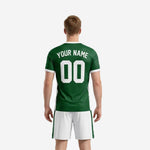 Close-up of Forest Green custom men's soccer jersey showing V-neck collar, white contrast panels, and sublimated team name and number