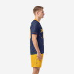 Men's custom soccer uniform in Navy Blue and Athletic Gold showing constellation sleeve detail and shorts side panel, left side view