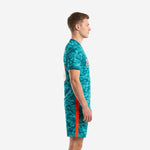 Men's teal camo soccer uniform side view showing blaze orange side stripe on matching shorts
