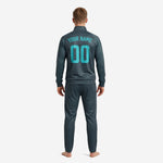 Mens custom tracksuit set in Steel Blue, side detail showing ribbed cuffs and full-zip stand collar with teal circuit-board accent print