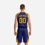 Opposite side view of navy and gold basketball uniform set highlighting the curved gold and black side panel on the shorts