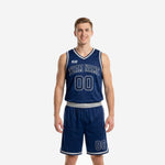 Custom navy basketball uniforms full set front view showing arched team name, front number on jersey, and matching navy shorts with silver stripe trim