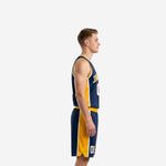 Side view of custom navy blue basketball uniform showing full-length gold side panel on jersey and matching shorts with white accent trim