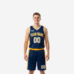 Custom navy blue basketball uniform for school programs with gold side panels, arced team name, and front number on adult male model - full set front view