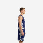 Custom navy blue basketball uniform side view displaying large silver lightning bolt panel running down the jersey and shorts