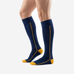 Custom navy blue soccer socks with gold toe block and calf piping, right side view showing full knee-high length