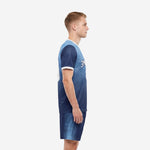 Men's soccer uniform in Navy Blue and Sky Blue dot-burst sublimation print, left side view showing sleeve cuff white trim and shorts panel detail