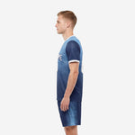 Custom men's soccer uniform set in Navy Blue and Sky Blue, right side view displaying gradient dot pattern from shoulder to hem on jersey and shorts