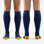 Complete pair of custom navy blue soccer socks with Athletic Gold diamond cuff and contrast toe and heel blocks