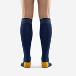 Close detail of Athletic Gold diamond grid pattern sublimated into the elastic cuff band of custom navy blue soccer socks