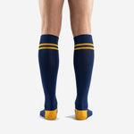 Navy Blue custom soccer socks with Athletic Gold reinforced heel and toe panels, close-up detail