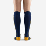 Navy blue soccer socks with athletic gold reinforced toe box and side piping detail, close side angle