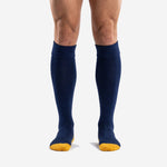 Custom navy blue soccer socks with Athletic Gold toe cap and ribbed turnover cuff, front view on adult male model