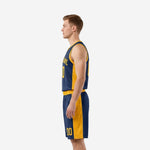 Side view of custom navy and gold basketball uniform set showing continuous gold side panel from jersey hem through shorts leg