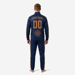 Close-up detail of old gold chevron stripe sublimation panel on custom navy and gold soccer tracksuit sleeve and pant seam