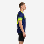 Sublimated navy and neon yellow soccer training jersey side view showing gradient sleeve fade on male model
