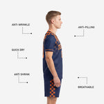 Full 2-piece custom navy and orange soccer uniform set showing jersey and matching shorts with sublimated checkerboard print