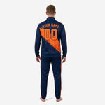 Back view of custom navy and orange soccer tracksuit showing player name and number 00 sublimated in orange panel on jacket