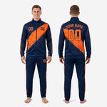 Orange and navy custom soccer tracksuit pants detail showing tapered leg cut and dual orange side stripes on matching track pants