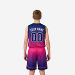 Opposite side view of custom printed navy and pink boys basketball uniform set on youth player showing chevron shorts hem accent