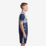 Custom navy blue and silver soccer kit side view showing silver side stripe panels on jersey and shorts