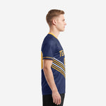 Custom navy soccer team shirts showing Athletic Gold and White diagonal chevron stripes wrapping the side panel, left profile view