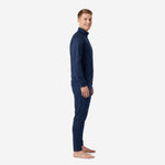 Side view of custom navy soccer tracksuit showing hex dot pattern across raglan sleeve and tapered pant leg with ribbed ankle hem