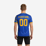 Close detail of Athletic Gold camo sublimation pattern on sleeve panel of custom navy soccer training jersey in Royal Blue