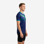 Custom navy blue and teal custom training top showing aurora gradient shoulder design and teal V-neck trim, left side view